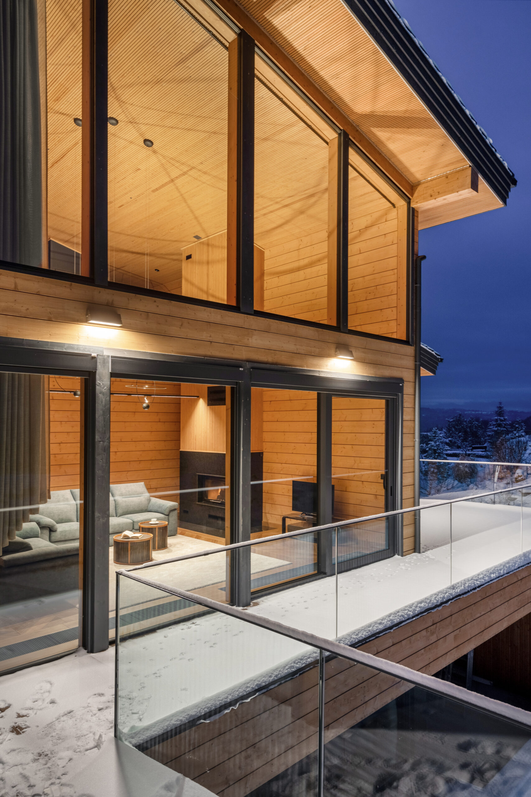 Terrace and glazed facade of the residence at dusk